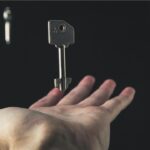 Hand holding a key representing open access publication.